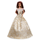 Mattel - Poupée Barbie Joyeux Noël 2025 - cheveux brun avec une robe argent et or-Sa robe argentée et dorée avec un imprimé damassé détaillé scintille et brille à travers l'emballage !