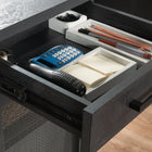 Sauder - La Collection Tiffin Line Bureau - Finition Raven Oak-Un système de gestion des cordons comprend deux œillets de bureau et des passages pour cordons