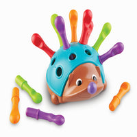 Learning Resources - Spike le hérisson de la motricité fine-Les piquants lisses et durables de ce jouet hérisson invitent au jeu tactile, et lorsque les petites mains saisissent les piquants épais et les poussent dans le dos de Spike, elles développent la force et la coordination des petits muscles de leurs mains dont ils ont besoin pour accomplir les tâches quotidiennes.