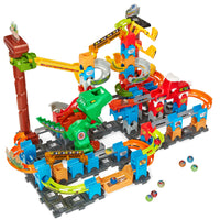 VTech - Circuit de course à sensations fortes Marble Rush T-Rex Dino-Un lanceur de snacks dino, un T-Rex mangeur et des rails rugissants se connectent facilement. Cet ensemble de 119 pièces comprend cinq billes colorées et cinq billes cascadeuses magiques avec des noyaux en métal.