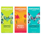 Montezuma’s - Assortiment de barres de chocolat au lait menthe poivrée, mangue et piment, noisettes caramélisées salées, 90 g chacune, paquet de 3-Trois barres de chocolat au lait Montezuma’s distinctes dans un même assortiment.