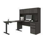 Bestar Prestige  Ensemble de 2 articles incluant un bureau assis-debout et un bureau avec huche - Gris écorce & Ardoise-Le bouton de commande situé sur la bordure avant de la surface de travail vous permet de choisir la hauteur de la table