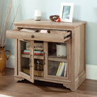 Sauder - 431439 La Collection Rollingwood Base de bibliothèque - Finition Brushed Oak-L'étagère réglable derrière des portes encadrées en verre trempé de sécurité peut accueillir des articles de différentes hauteurs.