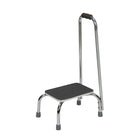 Bios â€“ Tabouret de pied DMI avec poignée-Le tabouret de pied DMI avec poignée a une structure en acier chromé et une surface texturée antidérapante