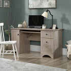 Sauder 59"W La Collection Sauder Select Bureau - Finition Laurel Oak-  Œillet passe-câble sur le bureau pour l’organisation des cordons électriques