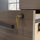 Sauder - La Collection Affirm Caisson mobile à 2 tiroirs - Finition Hudson Elm-Les roulettes cachées facilitent la mobilité et permettent de réarranger son bureau.